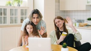 Family enjoying a video call together in a modern kitchen, showcasing diverse connections.